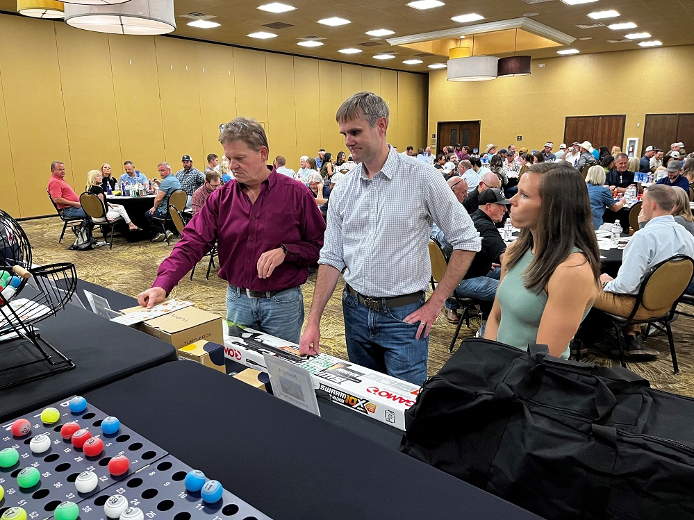 Photo: Hopkins County Health Care Foundation’s Man Bingo returns for its second year on April 10, 2025. Proceeds from the event go toward improving men’s healthcare in Hopkins County. Paul Eddins (left) and John Campbell (center) wait while their scorecards are being verified as volunteer Whitney Vaughan (right) looks on.