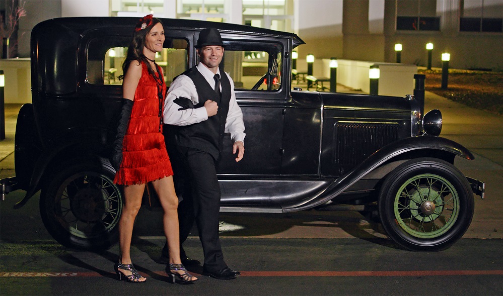 Photo 2: Dr. Jennifer Collar, PJC Fine Arts Division Chair and English faculty, is joined by her husband Chad for a preview of their Centennial Gala attire. The Model A was generously loaned by Scott Callaway.